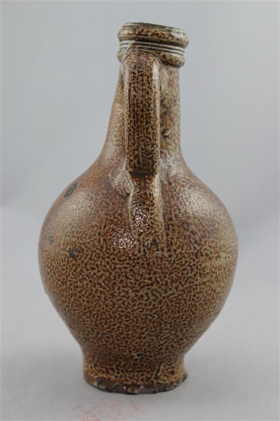 A German stoneware bellarmine jug, 16th / 17th century, 22cm.